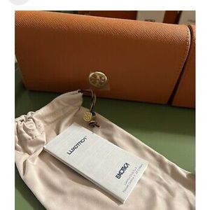 Tory Burch sunglass case.